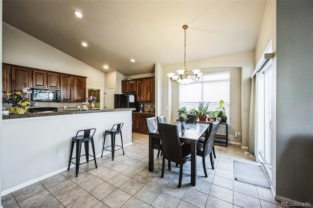 dining area with light tile patterned floors, high vaulted ceiling, recessed lighting, a notable chandelier, and baseboards