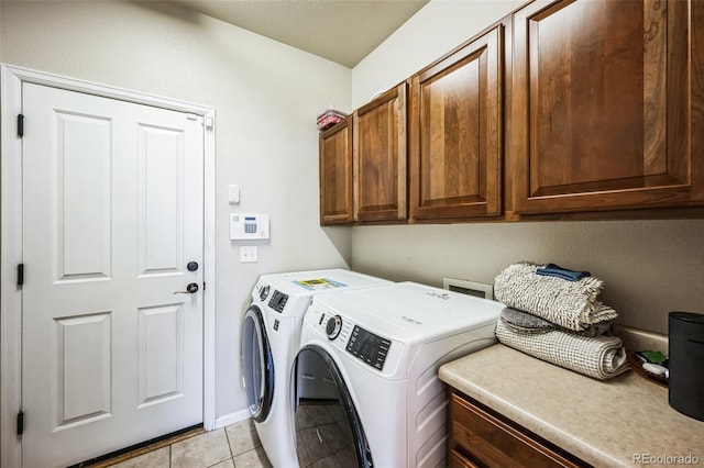 laundry area with cabinet space, washing machine and dryer, and light tile patterned flooring