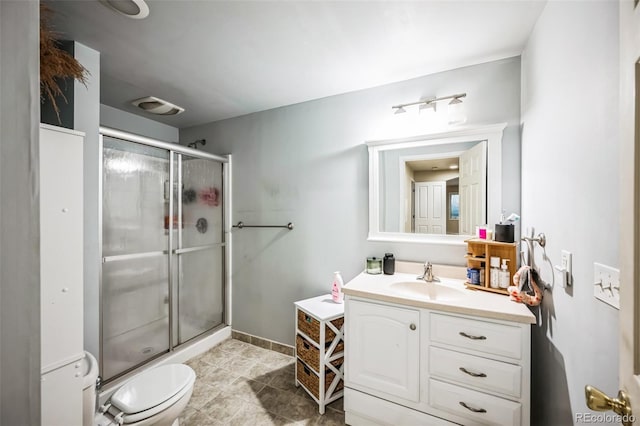 bathroom featuring toilet, a stall shower, vanity, and visible vents