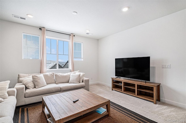 carpeted living room with a healthy amount of sunlight