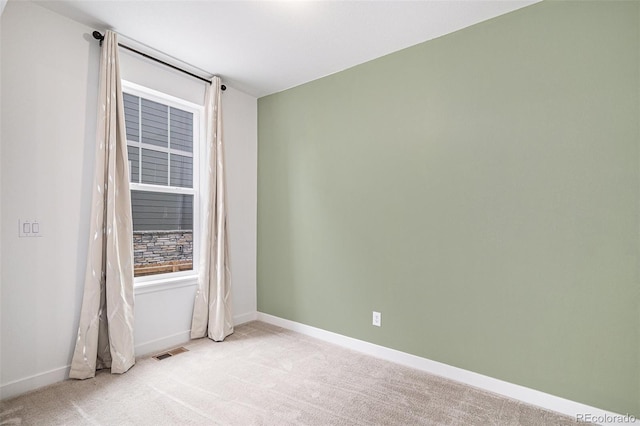 spare room with light colored carpet