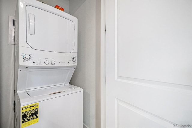 laundry room with stacked washing maching and dryer