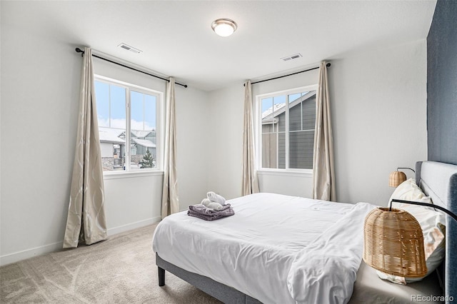 carpeted bedroom featuring multiple windows