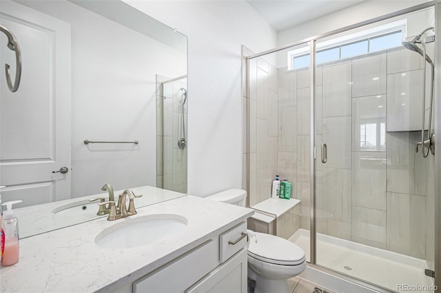 bathroom featuring an enclosed shower, vanity, and toilet