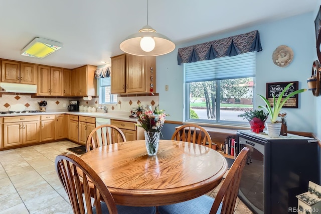dining space featuring light tile patterned floors and wine cooler