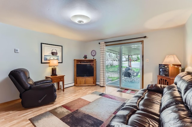 living room with light wood-style floors, baseboards, and baseboard heating