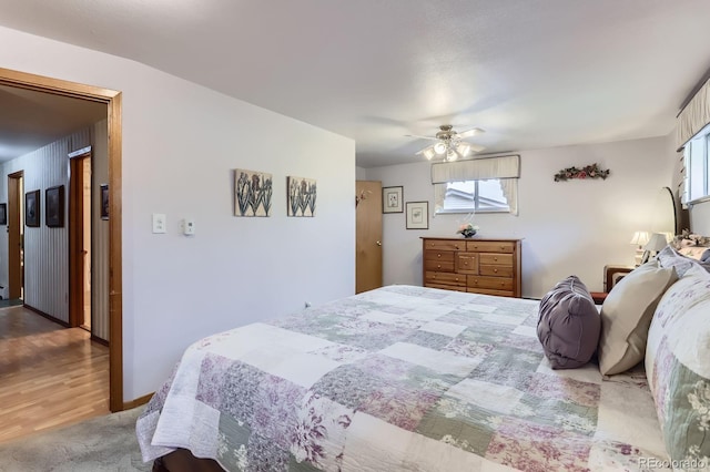 bedroom featuring carpet floors, a ceiling fan, and multiple windows