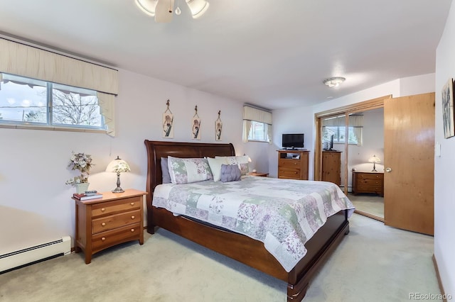 bedroom featuring a baseboard heating unit and light carpet
