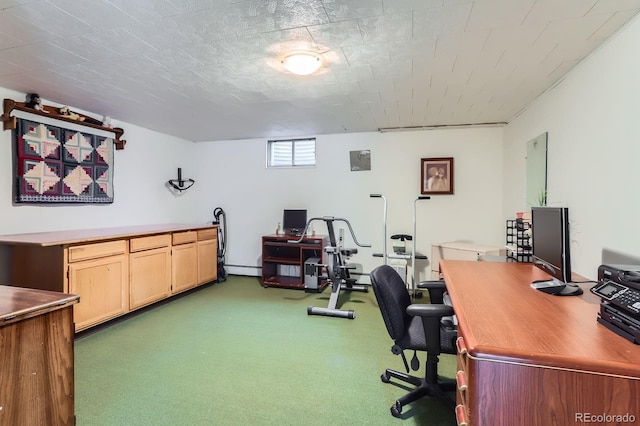 carpeted office with a baseboard radiator