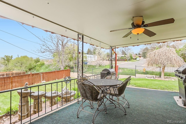 sunroom with a ceiling fan and outdoor dining space