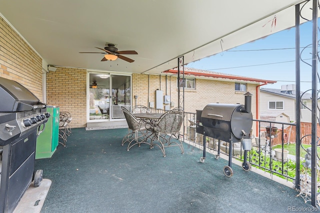 view of patio / terrace with grilling area, a ceiling fan, and outdoor dining area