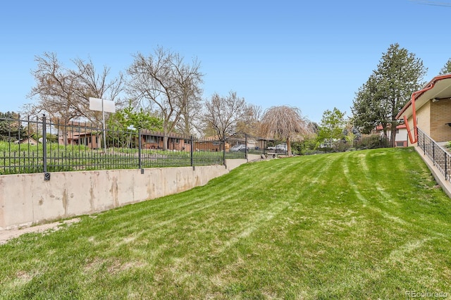 view of yard featuring fence and a residential view
