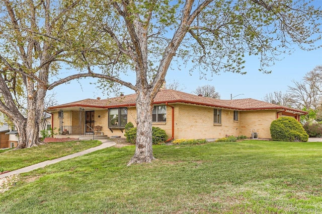 single story home featuring a front lawn and brick siding