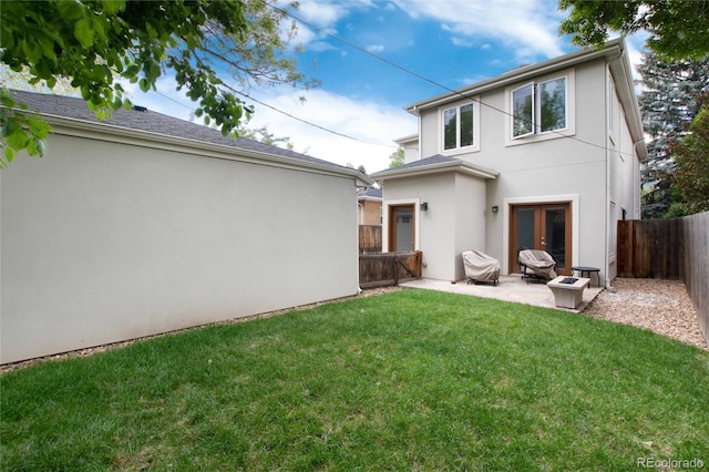 back of property featuring a yard, a patio, and french doors