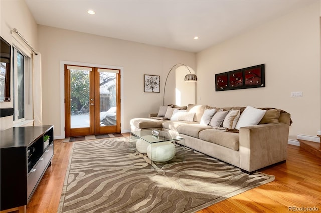 living room featuring french doors and light wood-type flooring