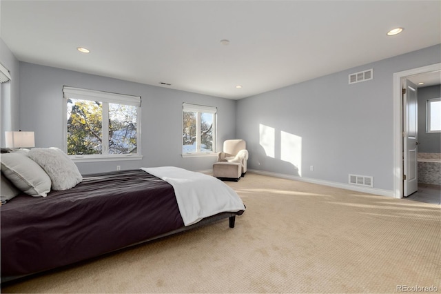 carpeted bedroom featuring connected bathroom