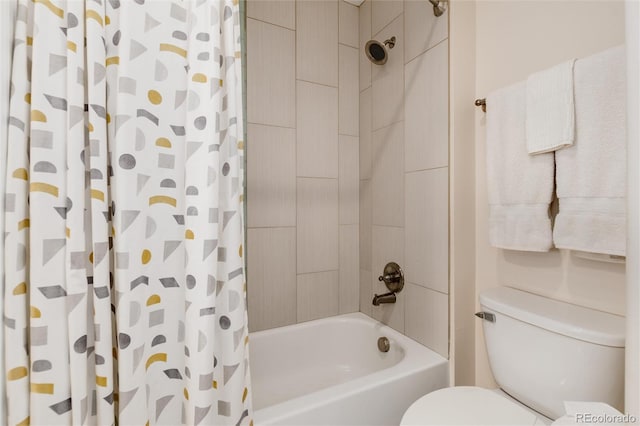 bathroom featuring shower / tub combo and toilet