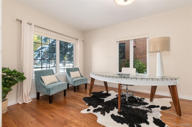 office area featuring baseboards and wood finished floors