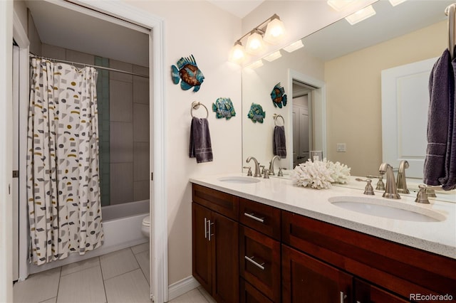 bathroom featuring tile patterned floors, shower / tub combo with curtain, a sink, and double vanity