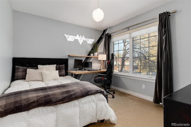 carpeted bedroom featuring baseboards and a skylight