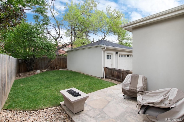view of yard with a fire pit, a patio area, and a fenced backyard