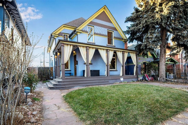 victorian home with a front yard