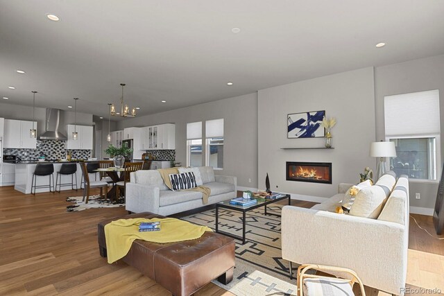 living room with a chandelier and light hardwood / wood-style floors