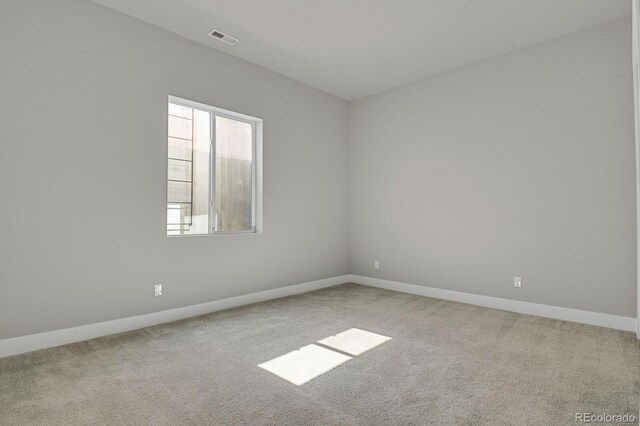 unfurnished room with light colored carpet