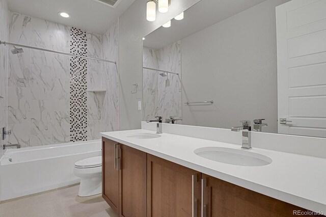 full bathroom with vanity, tiled shower / bath, tile patterned floors, and toilet