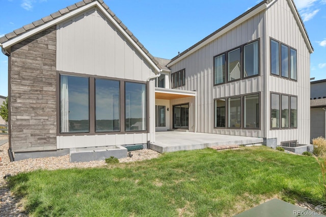 rear view of property featuring a yard