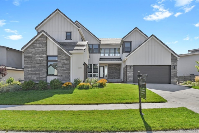 view of front facade with a garage and a front lawn