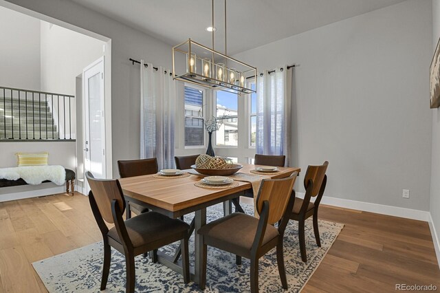 dining room featuring hardwood / wood-style floors and a notable chandelier