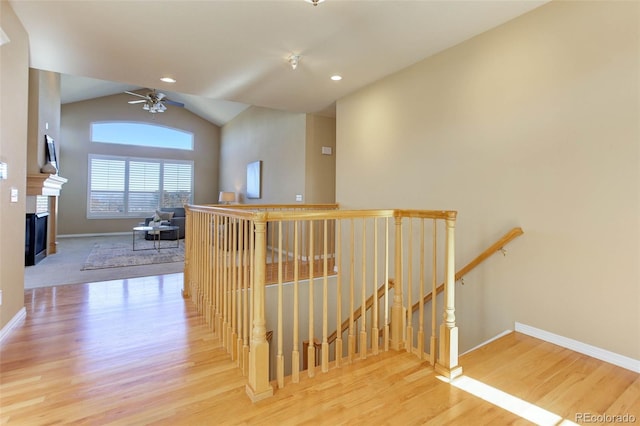 hallway with lofted ceiling and wood-type flooring