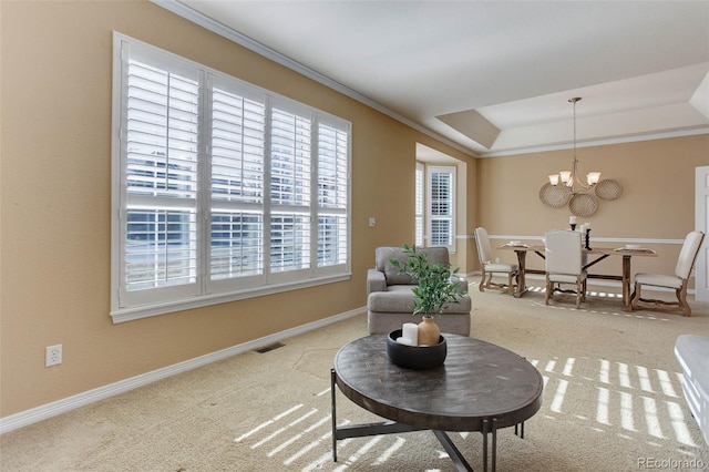 sitting room featuring ornamental molding, light colored carpet, a notable chandelier, and a tray ceiling