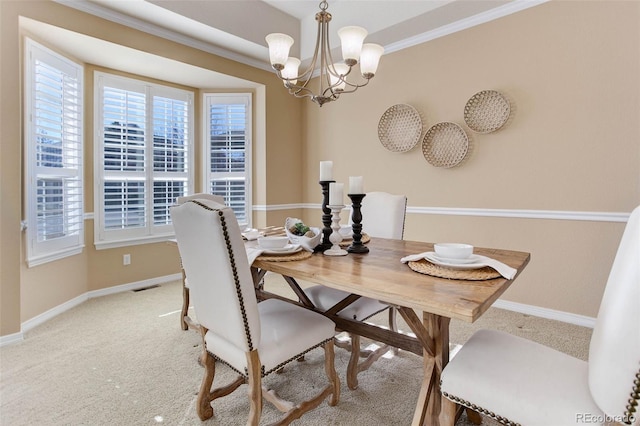 carpeted dining space with crown molding and an inviting chandelier