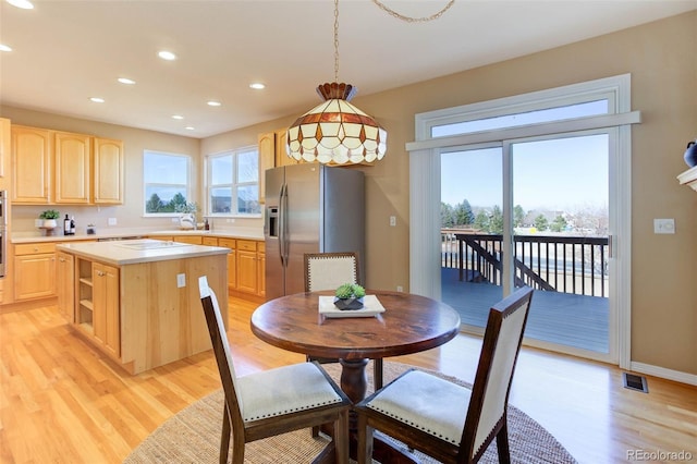 dining room with plenty of natural light and light wood-type flooring