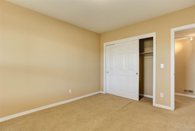 unfurnished bedroom featuring carpet flooring and a closet