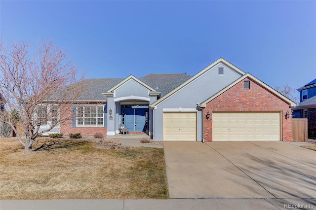 view of front of property with a garage and a front lawn