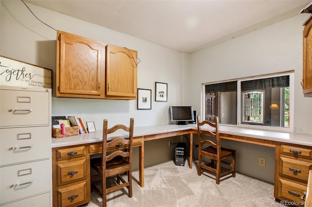 carpeted home office with built in desk