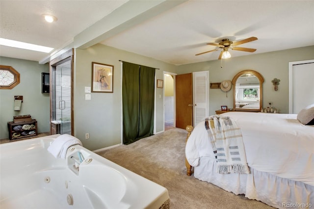 bedroom featuring carpet floors, ensuite bath, and ceiling fan