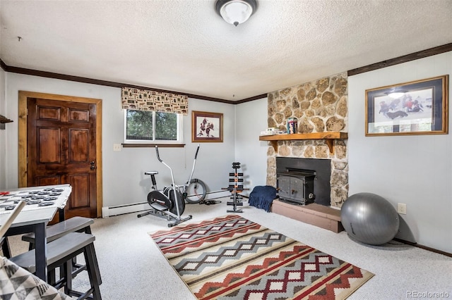 living room featuring a stone fireplace, a wood stove, a textured ceiling, a baseboard radiator, and carpet