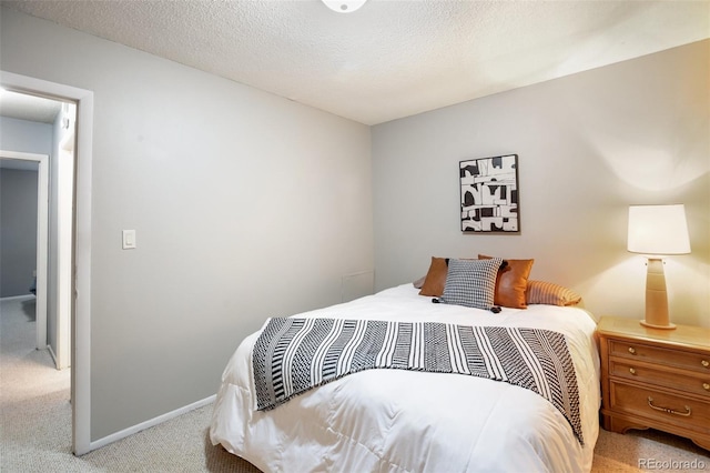 carpeted bedroom featuring a textured ceiling