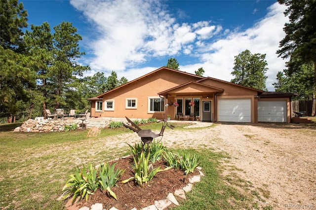 120 Blue Sky Ave, Woodland Park, CO 80863 - ranch-style home featuring a front lawn, stucco siding, driveway, and a garage