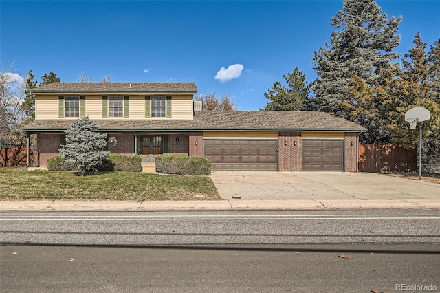 view of front property with a garage and a front yard