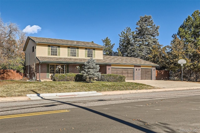 view of front property featuring a garage and a front yard