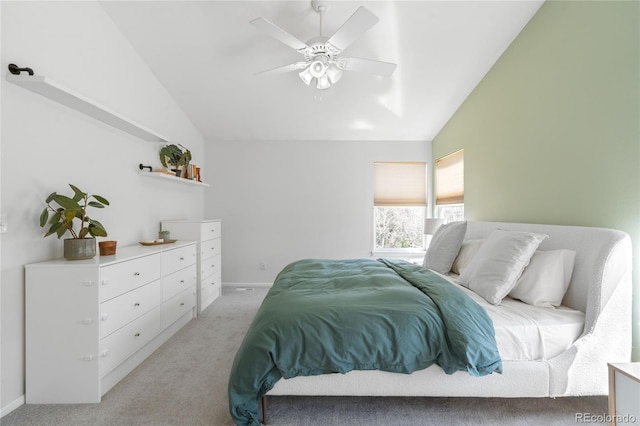 bedroom featuring ceiling fan, baseboards, vaulted ceiling, and light carpet
