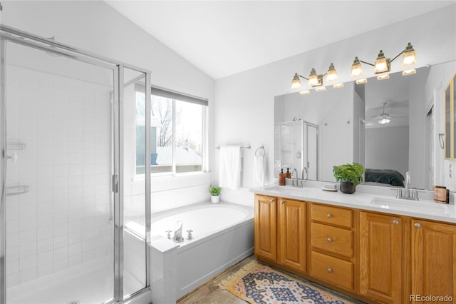 full bathroom with lofted ceiling, a shower stall, double vanity, ensuite bath, and a garden tub