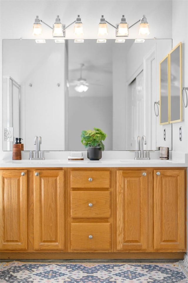 bathroom featuring double vanity, a sink, and ceiling fan
