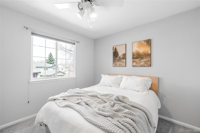 carpeted bedroom featuring baseboards and ceiling fan