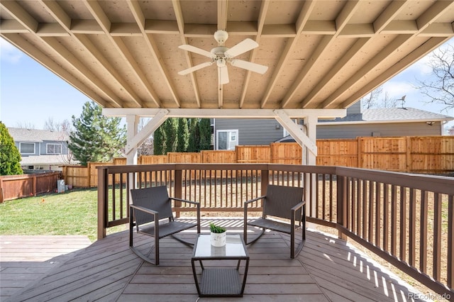 wooden terrace with a yard, a fenced backyard, and ceiling fan